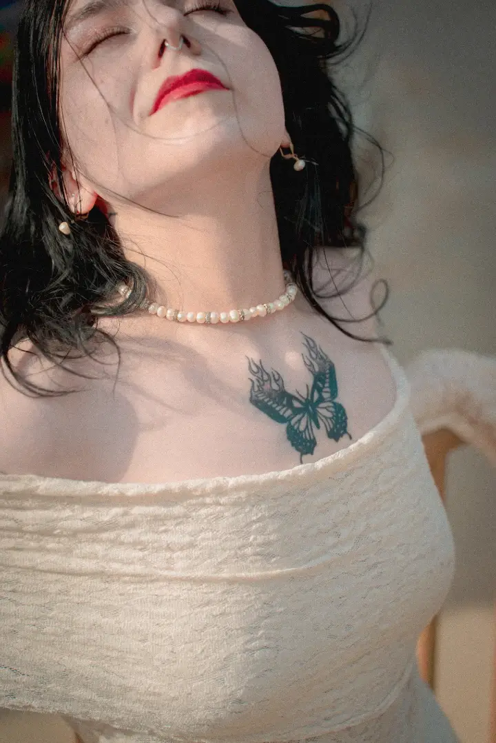 Fine line sternum tattoo by Bianca Ryan